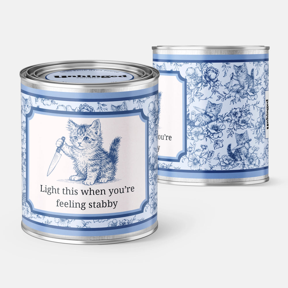 Unhinged Candles Light This When You're Feeling Stabby soy candle in a blue toile paint can with a kitten holding a knife