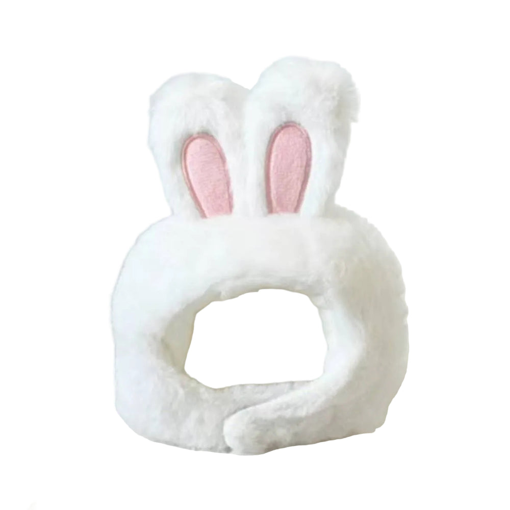 White fluffy bunny head pet bed with pink inner ears, photographed on a soft white surface against a light neutral background.
